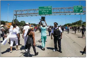  ?? AP/Chicago Sun-Times/ASHLEE REZIN ?? People gather Saturday on Interstate 94 in Chicago for a protest against gun violence.