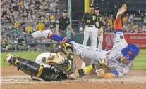  ?? GENE J. PUSKAR/ASSOCIATED PRESS ?? The Mets’ Michael Conforto, right, scores Friday to beat the tag from Pirates catcher Elias Diaz in the sixth inning in Pittsburgh. The Pirates won, 5-4.