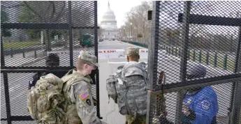  ?? JOHN MINCHILLO/AP ?? National Guard troops are let through a security gate Saturday near the U.S. Capitol.