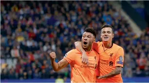  ?? AP ?? Alex Oxlade-Chamberlai­n celebrates with Philippe Coutinho after scoring a goal against Maribor during a Champions League match. —