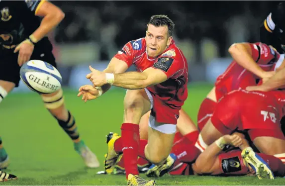  ??  ?? > Gareth Davies fires out a pass during the Scarlets’ Champions Cup game at Northampto­n. James Davies, below right, has signed a new Scarlets deal