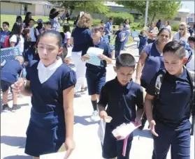  ??  ?? Students leave McKinley Elementary Monday after the first day of the school year. PHOTO MICHAEL MARESH