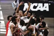  ??  ?? Houston players celebrate after beating Houston 67-61 on Monday in Indianapol­is to advance to the Final Four since their halcyon years in the 1980s.