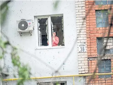  ?? ?? BLASTS: Residents survey the damage after shelling in the Korabel’nyi district.