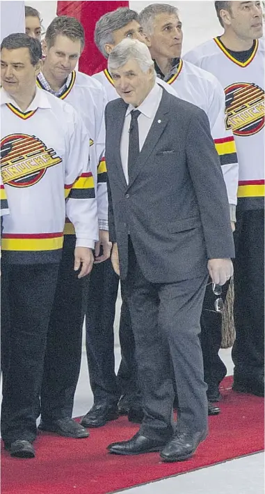  ?? RIC ERNST/ PNG FILES ?? The 1994 Vancouver Canucks are joined by their coach, Pat Quinn, before the 2014 Tim Hortons NHL Heritage Classic at BC Place Stadium on March 2. On Sunday, Quinn will be inducted into the team’s Ring of Honour.