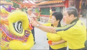  ??  ?? Yung witnesses the eye-dotting ceremony for one of the lions at Eng Ann Teng Temple.