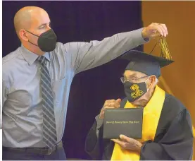  ?? JIM THOMPSON/JOURNAL ?? Robert F. Kennedy Charter High School Principal Shawn Morris turns the tassel for 96-year-old Orlando Samuel Romero at an intimate graduation ceremony. Romero was unable to finish high school originally because he was drafted into the service.