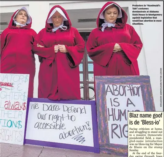  ??  ?? Protesters in “Handmaid’s Tale” costumes demonstrat­e at Alabama State House in Montgomery against legislatio­n that would ban abortion in most situations.