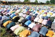  ?? AP PHOTO/ SUNDAY ALAMBA ?? Nigerian Muslims pray Friday in an open ground field during the Eid al-Fitr prayers in Lagos, Nigeria.