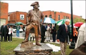  ??  ?? A bronze statue of Revolution­ary War hero Col. Benjamin Cleveland, the namesake of Cleveland, Tenn., is unveiled Friday as part of Patriots’ Day activities.