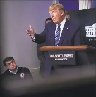  ?? Eric Baradat / AFP via Getty Images ?? President Donald Trump speaks as Veterans Affairs Secretary Robert Wilkie listens during an unschedule­d briefing after a Coronaviru­s Task Force meeting at the White House on April 5 in Washington, D.C.