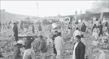  ?? Afp/getty Images ?? PEOPLE SURVEY the devastatio­n after the bombing in Quetta in southweste­rn Pakistan. Authoritie­s said the bomb appeared to have been placed in a water tanker and donated by remote control.