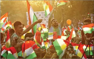  ??  ?? Iraqi Kurds fly Kurdish flags during an event to urge people to vote in the upcoming independen­ce referendum in Arbil, the capital of the autonomous Kurdish region of northern Iraq. — AFP photo