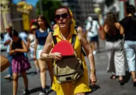  ?? MANU FERNANDEZ/ASSOCIATED PRESS/FILE ?? A woman fanned herself in Madrid in July, as Spain recorded its third hottest summer since records began.