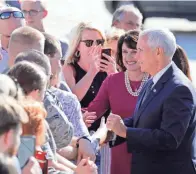  ?? RICK WOOD / MILWAUKEE JOURNAL SENTINEL ?? Vice President Mike Pence and Republican U.S. Senate candidate Leah Vukmir greet supporters at Mitchell Internatio­nal Airport before a fundraiser for Vukmir on Thursday.