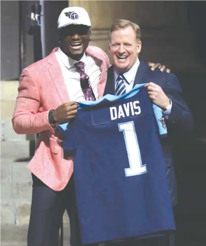  ?? | AP ?? Western Michigan receiver Corey Davis poses with commission­er Roger Goodell after being selected fifth by the Titans on Thursday.