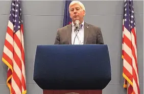  ?? DAVID EGGERT/ASSOCIATED PRESS ?? Then-Michigan Gov. Rick Snyder speaks at a news conference in his office in Lansing, Mich., in Spetmber 2018. Snyder has been charged with willful neglect of duty.