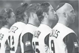  ?? KOJI SASAHARA, AP ?? Players for Team Israel listen to the country’s national anthem before Monday’s World Baseball Classic game against the Netherland­s in Tokyo. The Dutch team won 12-2.