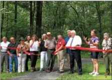 ?? REBECCA BLANCHARD — DIGITAL FIRST MEDIA ?? Representa­tives of the Schuylkill Highlands Conservati­on Landscape, their partners, community leaders, and politician­s celebrate the opening of the new trail which connects Hopewell Big Woods to French Creek State Park. This is a handicap accessible...