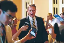  ?? PABLO MARTINEZ MONSIVAIS/ASSOCIATED PRESS FILE PHOTO ?? Sen. Jeff Flake, R-Ariz., speaks to members of the media July 13 as he walks to a meeting on Capitol Hill in Washington. Flake takes aim at President Donald Trump and his own party in a new book.