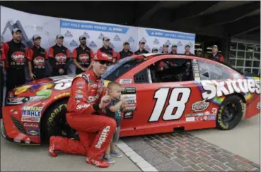  ?? DARRON CUMMINGS — THE ASSOCIATED PRESS ?? Kyle Busch poses with his son, Brexton, after winning the pole for the Brickyard 400 at Indianapol­is Motor Speedway.