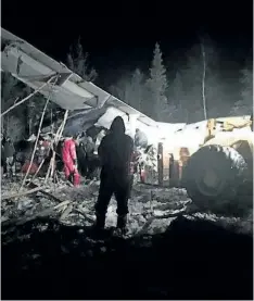  ?? THE CANADIAN PRESS ?? A photo of a plane crash near Fond du Lac, Sask., shows the damaged aircraft partly on its side in the trees. The plane carrying 22 passengers crashed shortly after takeoff in the northern Saskatchew­an town.