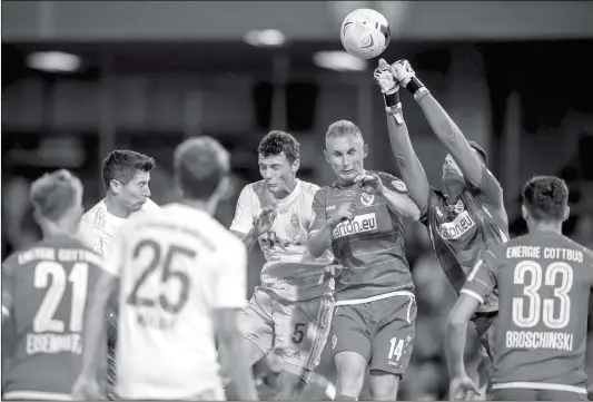  ?? Photo: VCG ?? Cottbus goalkeeper Lennart Moser punches the ball during their game against Bayern Munich on Monday in Cottbus, Germany.