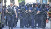  ??  ?? Armed police officers arrive at The Shard in the London Bridge quarter after the terror attack on Saturday night.