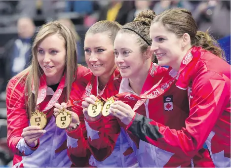  ?? JUSTIN TANG/THE CANADIAN PRESS ?? Skip Rachel Homan, third Emma Miskew, second Joanne Courtney and lead Lisa Weagle hold up their medals after winning the women’s final 6-5 over Cheslea Carey’s rink at the Roar of the Rings Olympic trials on Sunday in Ottawa.