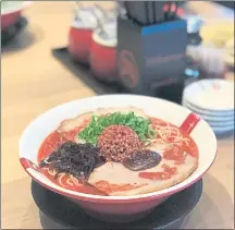  ??  ?? Ramen Nagi’s Red King bowl features a spicy, red chile oil-spiked broth, pork belly and a pork-red miso ball.