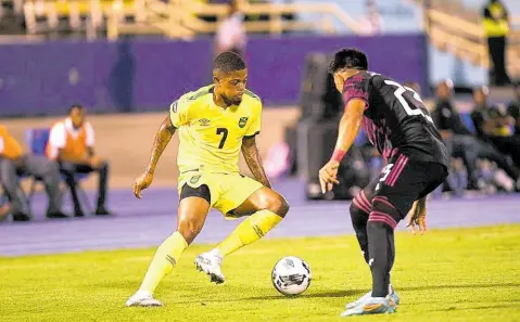  ?? FILE ?? Leon Bailey (left) in action for Jamaica against Mexico’s Jesus Gallardo during a Concacaf Nations League match at the National Stadium in December 2022.