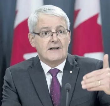  ?? ADRIAN WYLD/THE CANADIAN PRESS ?? Transport Minister Marc Garneau speaks at a news conference in Ottawa on Thursday. Garneau is proposing the creation of a tough national standard to penalize distracted drivers using their cellphones on the road.