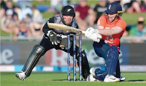  ?? — AFP ?? England’s captain Eoin Morgan (right) plays a shot watched by New Zealand’s wicket-keeper Tim Seifert during the Twenty20 cricket match against New Zealand at Mclean Park in Napier on Friday.