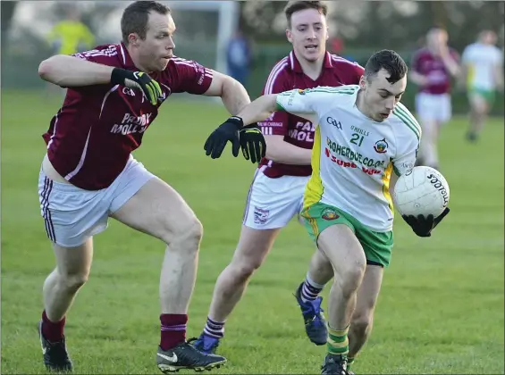  ??  ?? Boherbue’s Patrick Murphy breaks away from Rockchapel challenges during the Donagh Hickeys Motors Duhallow Cup in Cullen. Photo by John Tarrant