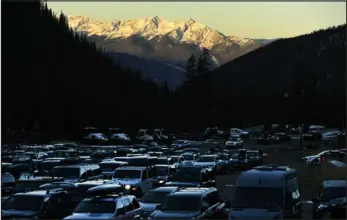  ?? HELEN H. RICHARDSON — THE DENVER POST ?? Cars arrive as the sun rises to get a parking spot for opening day at Arapahoe Basin Ski Area on October 17, 2021.