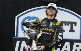  ?? DARRON CUMMINGS / AP ?? Colton Herta on Saturday picked up his first win of the IndyCar season with a drive through the rain on the road course inside Indianapol­is Motor Speedway.