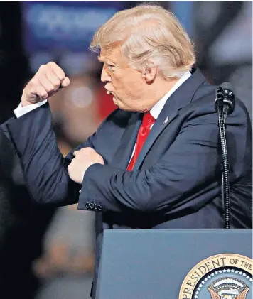  ??  ?? A jubilant Donald Trump, above, flexes a muscle at a rally in Topeka, Kansas, and, top left, chief justice John G Roberts Jnr administer­s the constituti­onal oath to Brett Kavanaugh with his family at his side