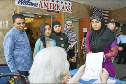  ?? FILE PHOTO ?? New citizens register to vote following the city’s annual naturaliza­tion ceremony at Middletown City Hall. Mayor Dan Drew declared the city a safe haven for immigrants last week, saying local law enforcemen­t will not do the U.S. government’s job by...