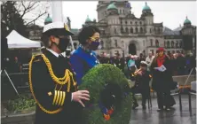  ?? CHAD HIPOLITO/THE CANADIAN PRESS ?? Lt.-Gov. Janet Austin lays a wreath during Remembranc­e Day services at the cenotaph in Victoria on Thursday.