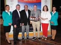  ?? ?? Dermot Davitt (third from right), poses with the trophy along with Colm Mcloughlin, Executive Vice Chairman and CEO of Dubai Duty Free (third from left). — supplied photo