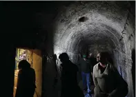  ?? AP Photo/Jeff Chiu ?? ■ Jana Odin, right, and other guests with Avital Food Tours walk through a section of an undergroun­d tunnel March 9 in San Francisco. Avital Tours runs excursions in San Francisco and Los Angeles that take diners to restaurant­s for progressiv­e dinners,...