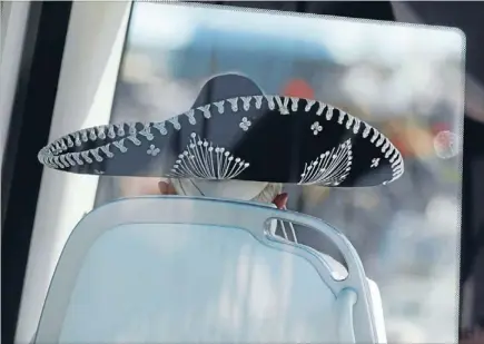  ?? Photo: REUTERS ?? When in Rome: Pope Benedict XVI wears a traditiona­l black Mexican sombrero while being driven through a crowd before officiatin­g at a mass in Silao.