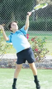  ??  ?? Tarj Irwin serves at full stretch in Baw Baw junior tennis.