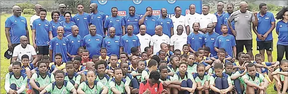  ?? (Pics: Machawe Fakudze) ?? The developmen­t players with local coaches, EFA executive committee members and FIFA Technical Consultant Serane Letsoaka (wearing a grey shirt) during the programme launch at the EFA Technical Centre at Lobamba yesterday.