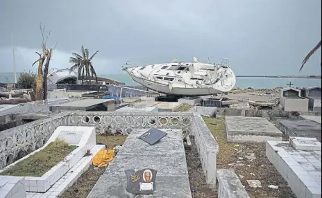  ?? AFP ?? Hurricane Irma dumps a boat in a cemetery in Marigot, SaintMarti­n island, after the powerful storm devastated the Caribbean island. Another hurricane, Jose, is expected to batter the island.
