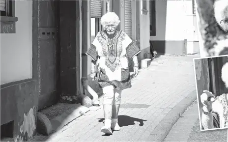  ?? — AFP photos ?? Heise walks on a street in the southweste­rn German city of Kirchheimb­olanden.