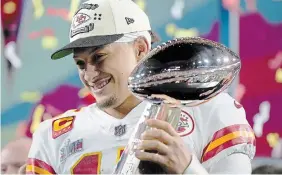  ?? MATT SLOCUM THE ASSOCIATED PRESS ?? Kansas City Chiefs quarterbac­k Patrick Mahomes holds the Lombardi trophy after their win against the Philadelph­ia Eagles in Super Bowl 57 on Sunday.