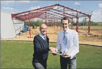  ??  ?? family firm: Managing director Tony Dalton, left, with son, and director, Matthew in front of the new extension being built.