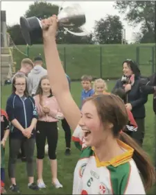  ??  ?? Kiltegan captain Hope Tallon lifts the under-16 ‘A’ cup.