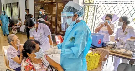  ??  ?? Health workers of the Sri Lanka’s army inoculate senior citizens and elderly people in Colombo (AFP)
